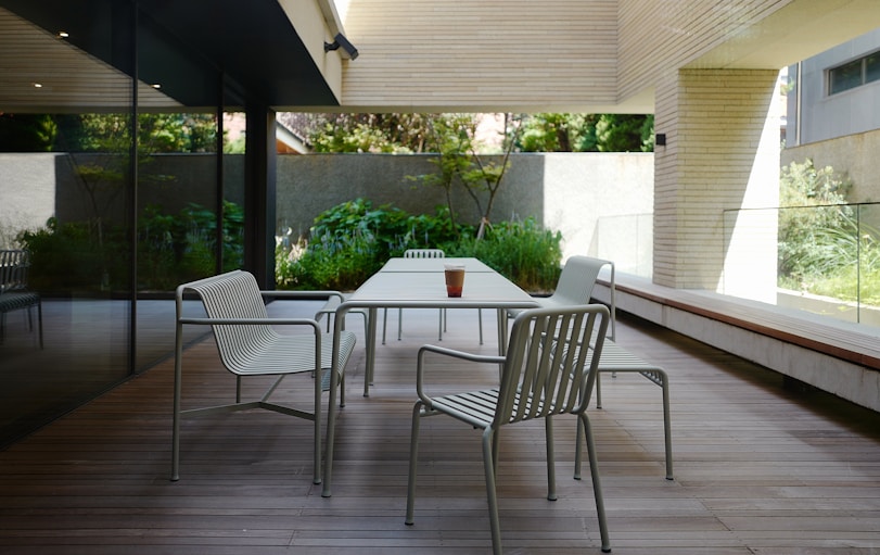 a table and chairs on a wooden deck