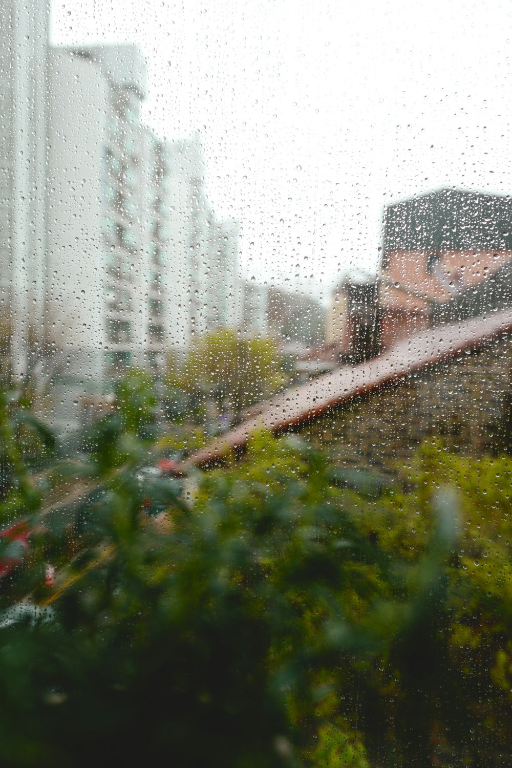 a view of a building through a rain covered window