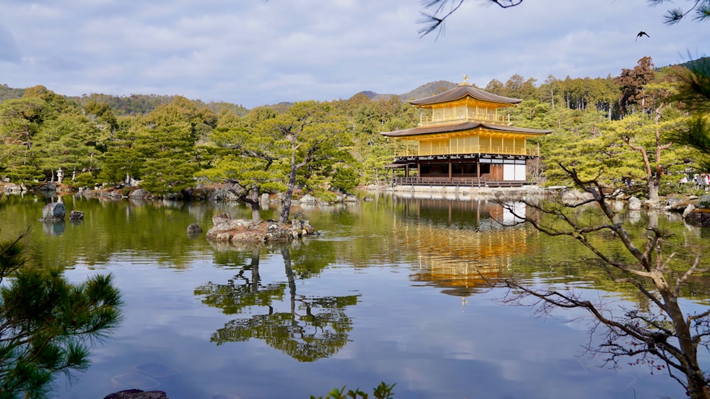 a pond with a pagoda in the middle of it