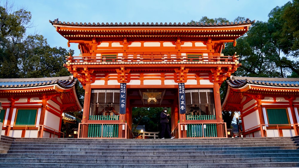 a tall orange building with a staircase leading up to it