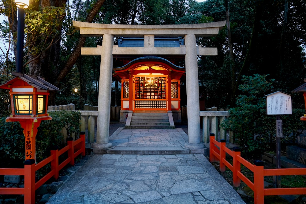 a red and white shrine surrounded by trees