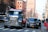 a truck driving down a street next to a car