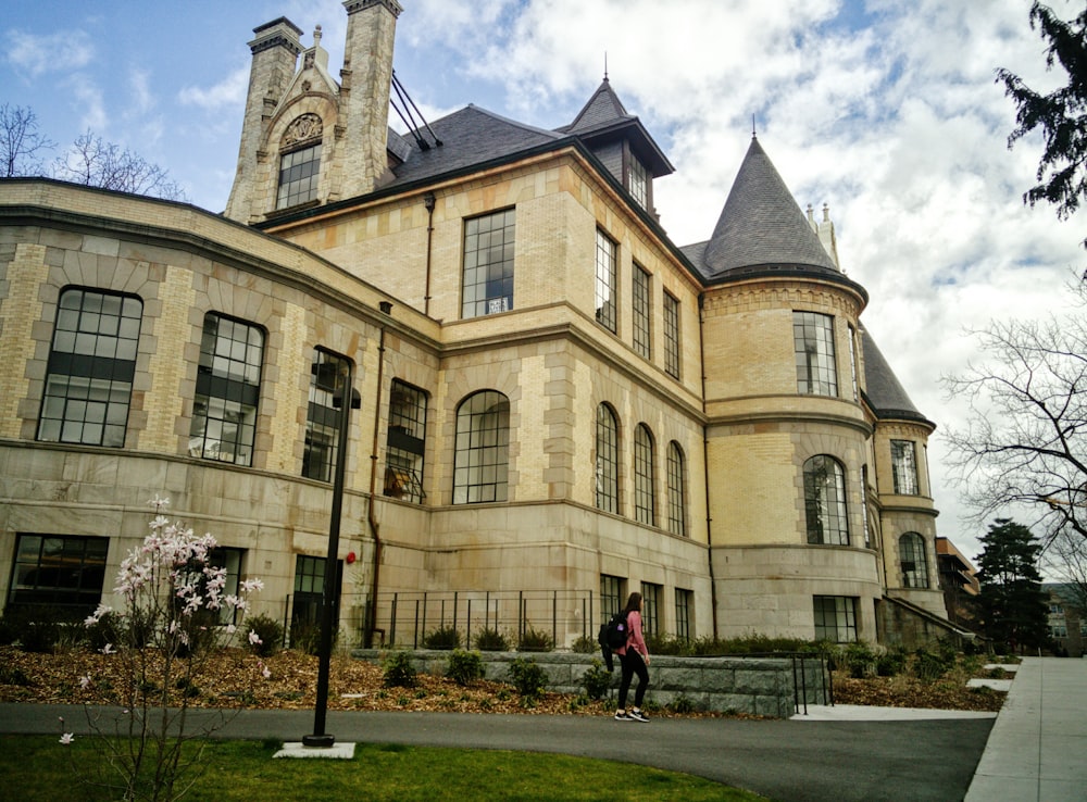 a person walking in front of a large building