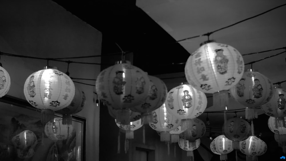 a group of paper lanterns hanging from a ceiling