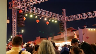 a crowd of people standing around a stage