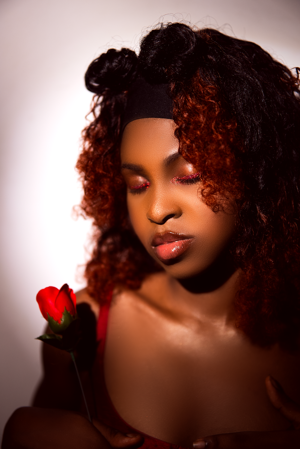 a woman with a red rose in her hand