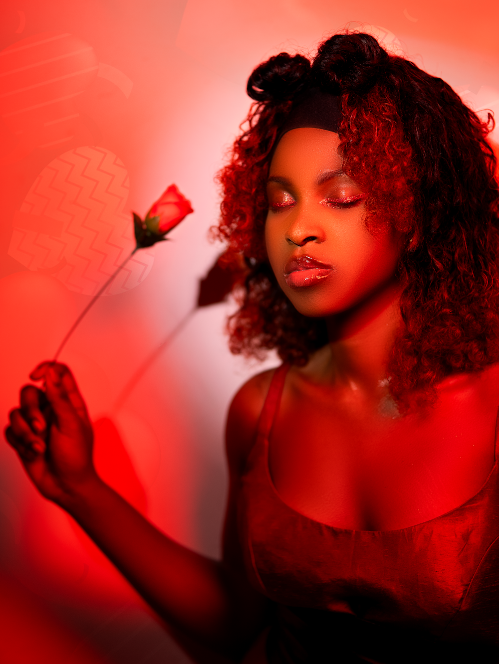 a woman in a red dress holding a flower