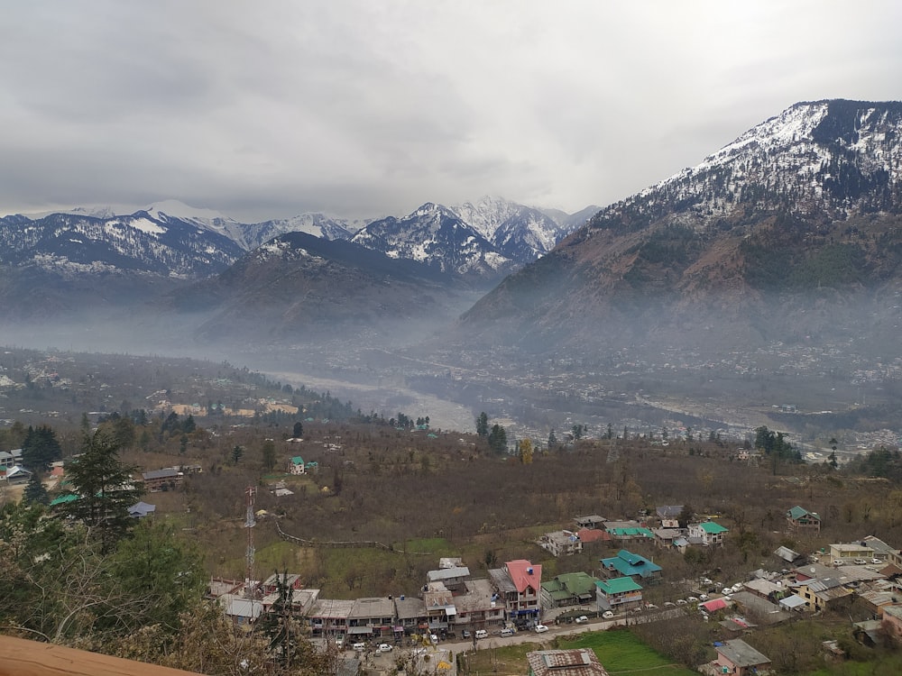 a view of a town with mountains in the background