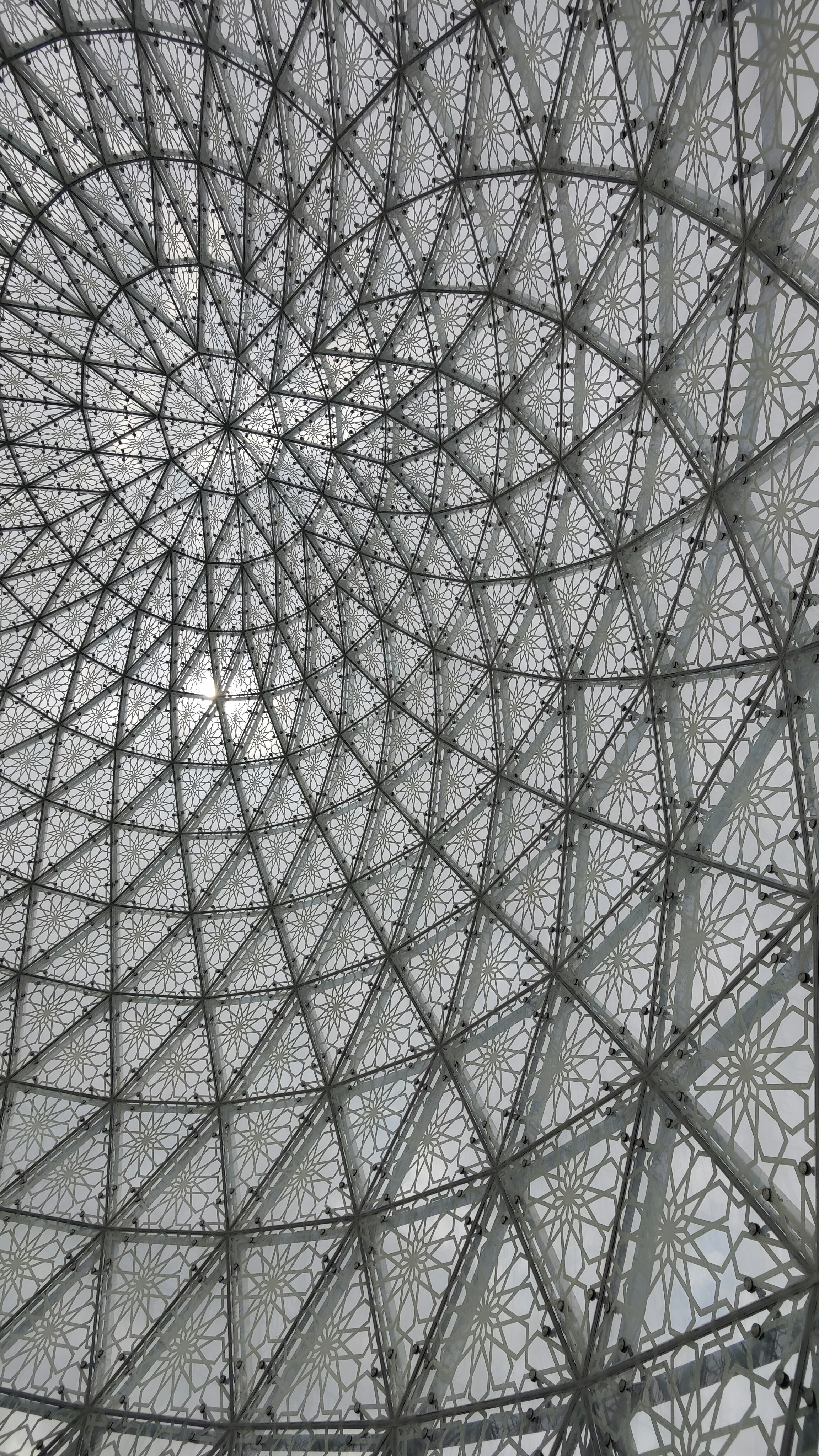 배경에 태양이 있는 금속 구조물의 클로즈업