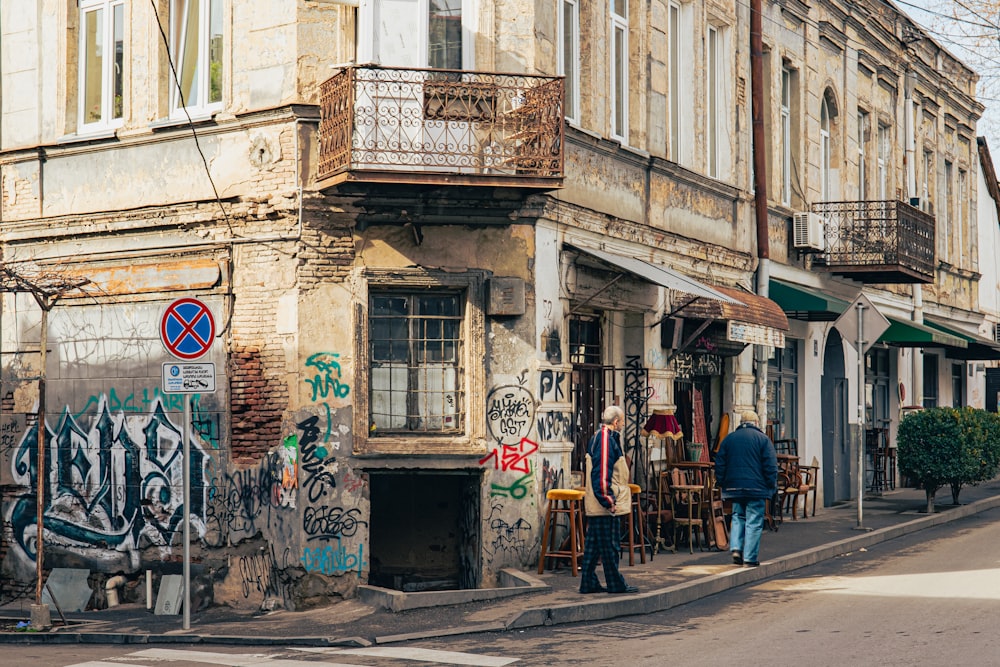 a couple of people that are standing outside of a building