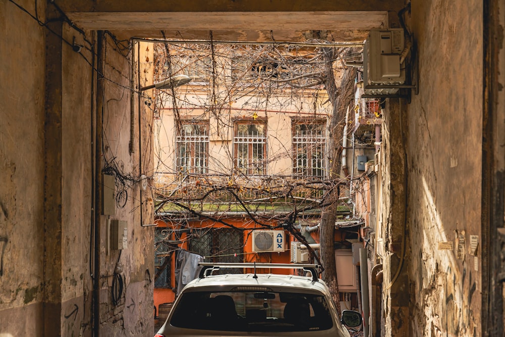 a car parked in a narrow alley way
