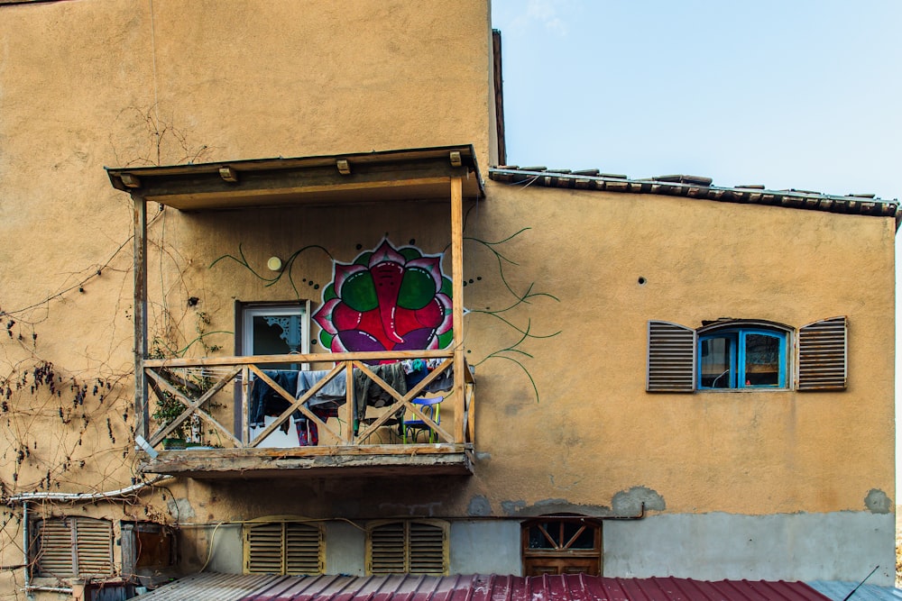 a building with a balcony and a painted window