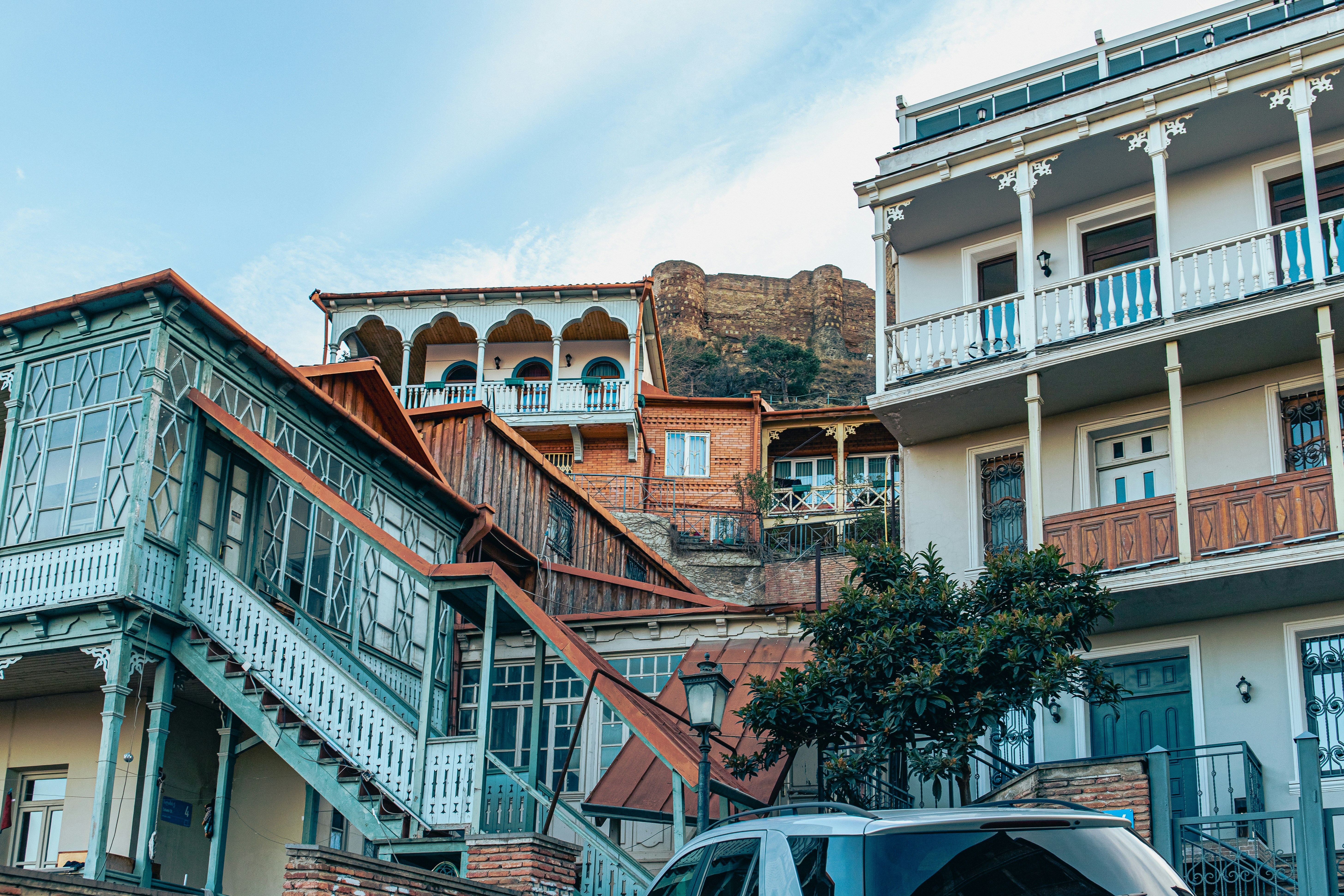 a van parked in front of a building with balconies