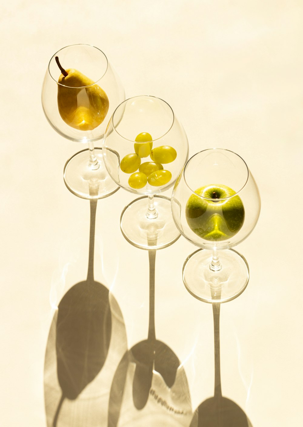 a group of wine glasses with olives in them