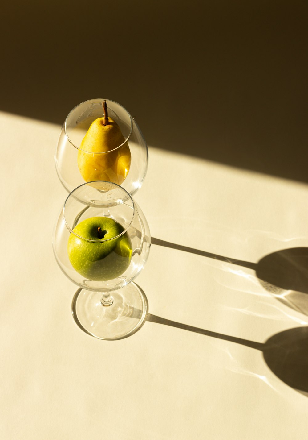 a couple of glasses with some fruit in them
