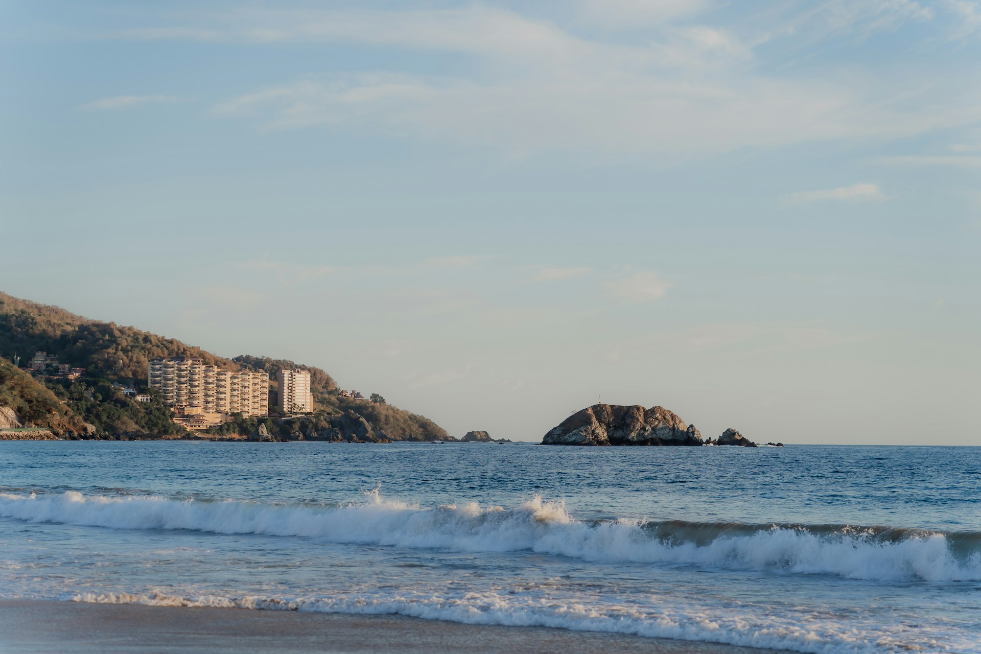 a view of a beach with a building in the distance