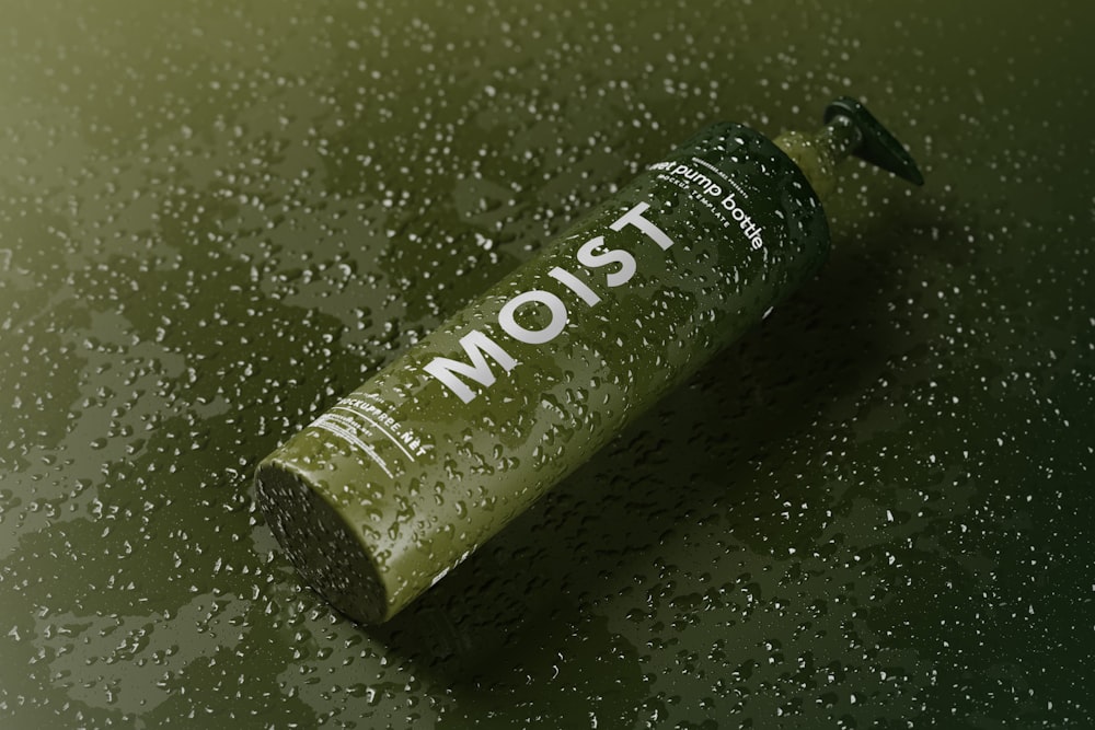 a close up of a bottle on a wet surface