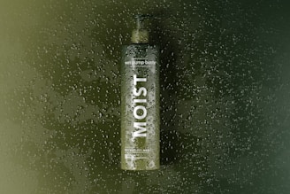 a bottle of alcohol sitting on top of a window