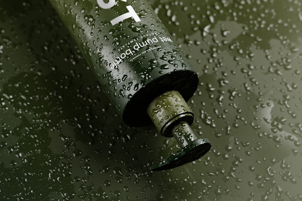 a close up of a water bottle on a wet surface