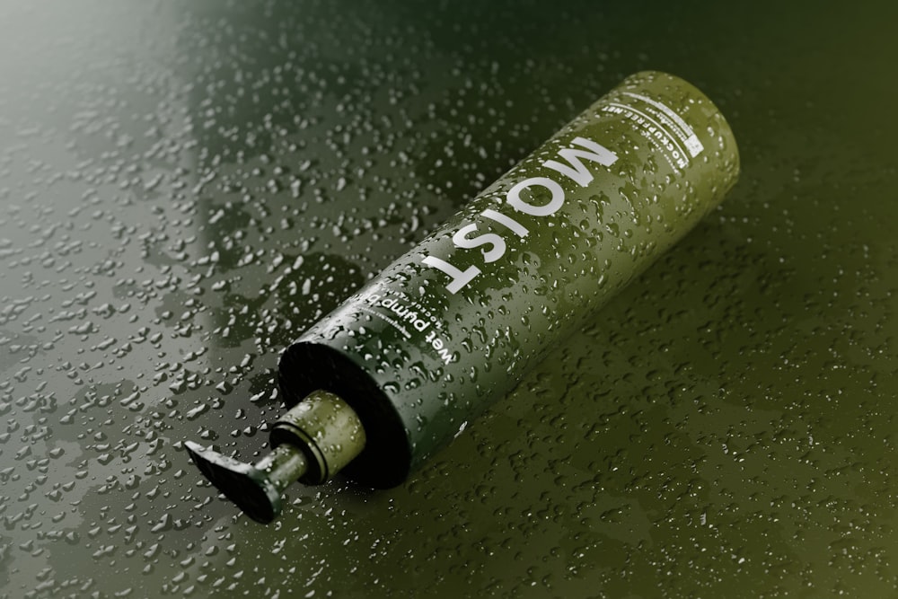 a bottle of alcohol sitting on top of a wet surface