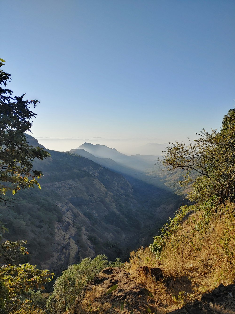 a view of the mountains from the top of a hill