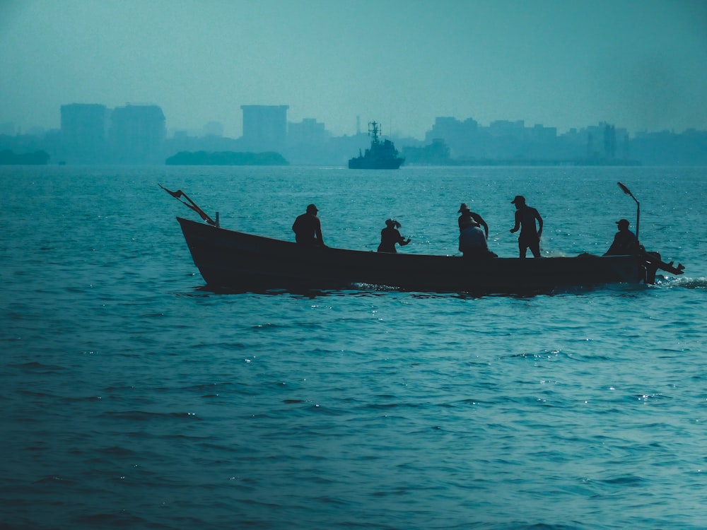 a group of people riding on the back of a boat