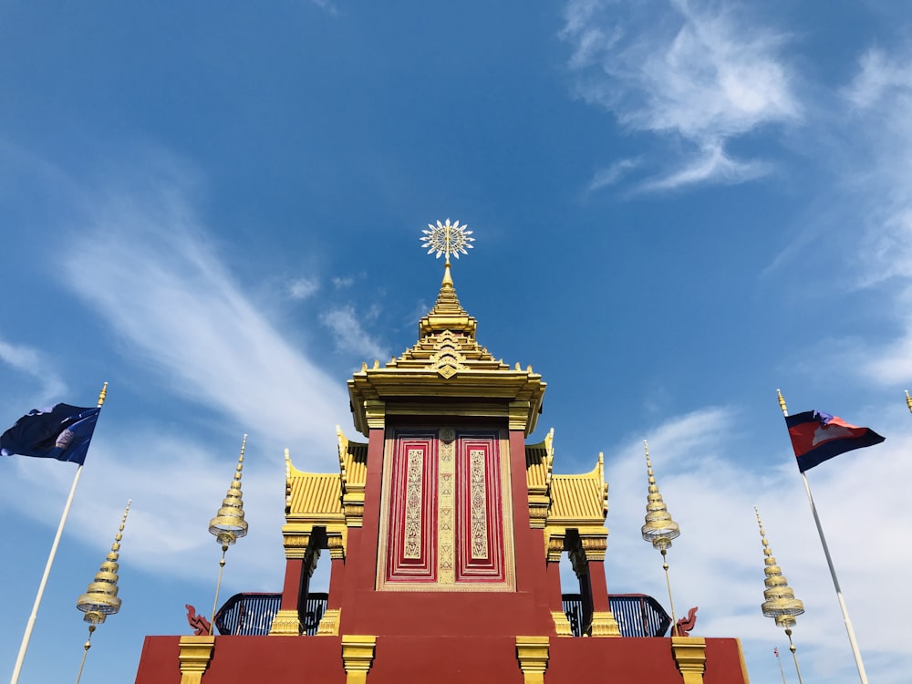 a red and yellow building with a clock on top