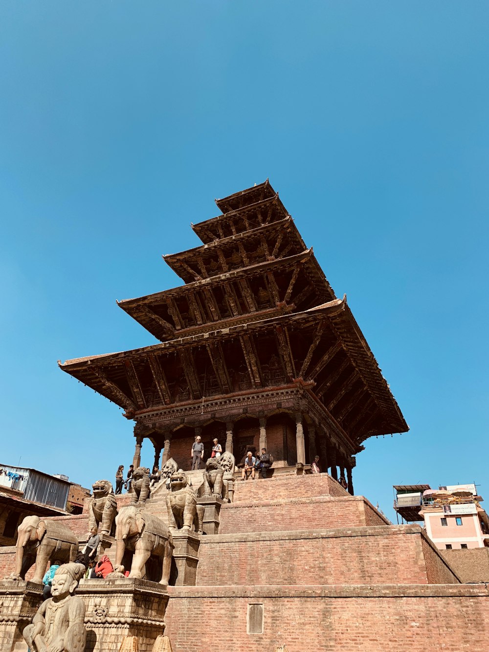 a tall wooden structure with statues on top of it