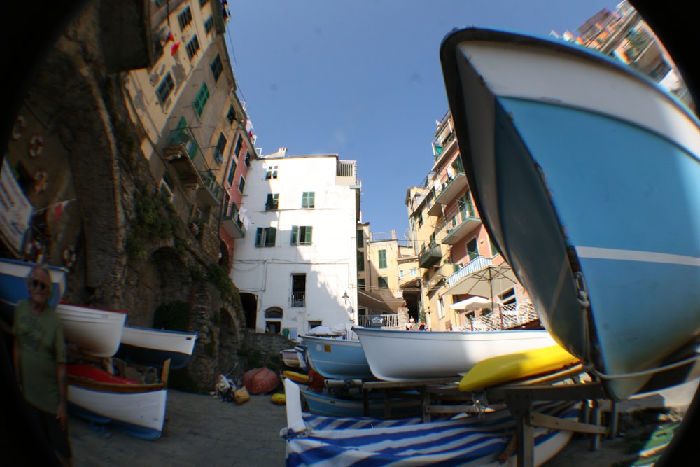 a boat sitting on top of a beach next to a building