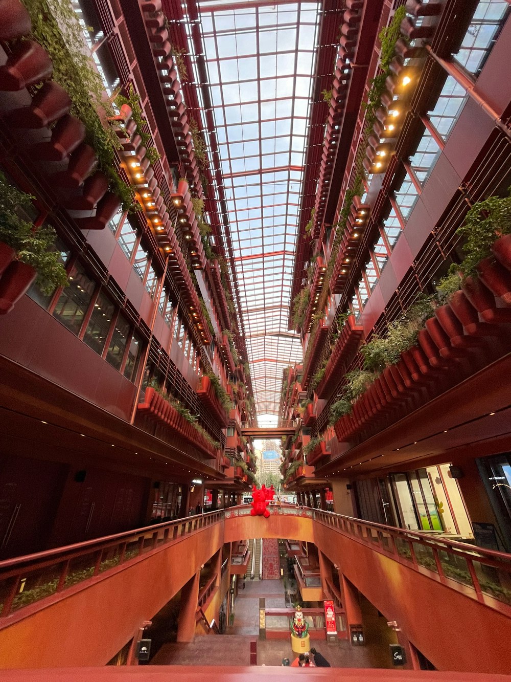 a large atrium with plants growing on the ceiling