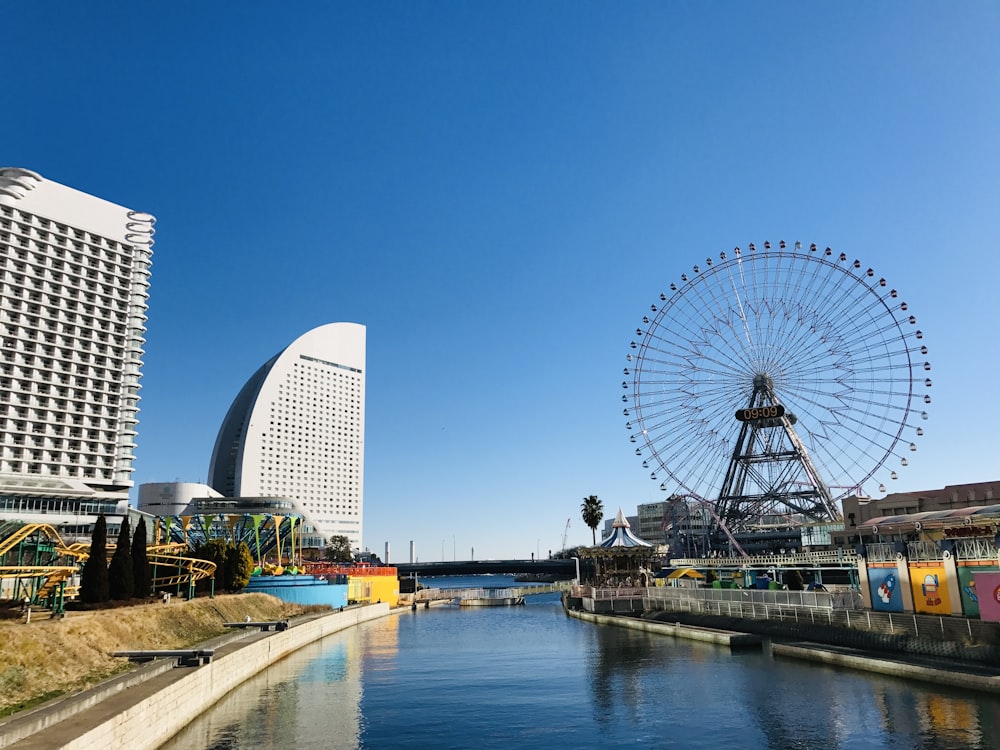 a ferris wheel sitting next to a body of water