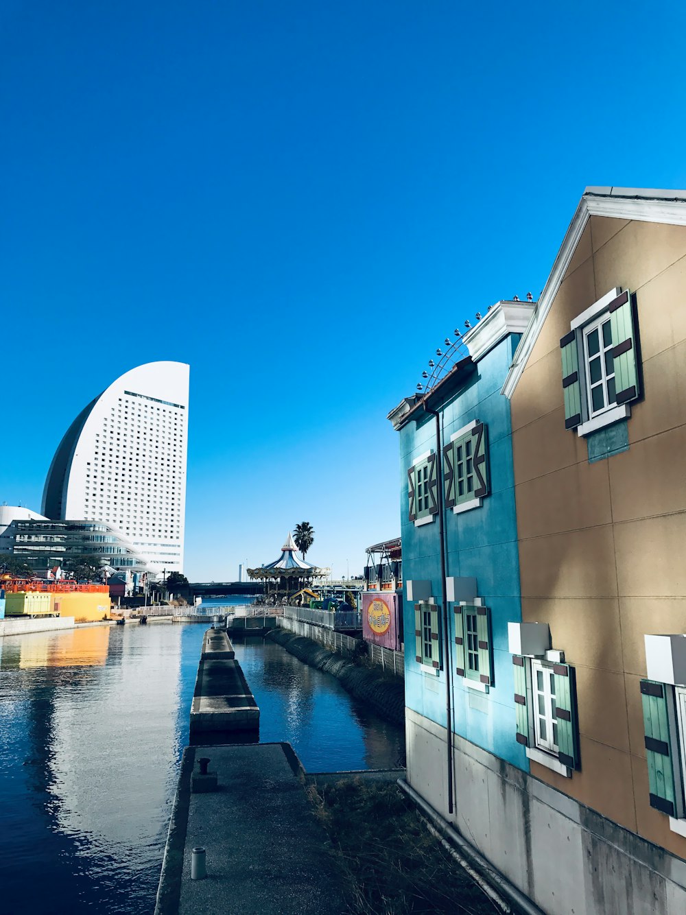 a body of water next to a tall building