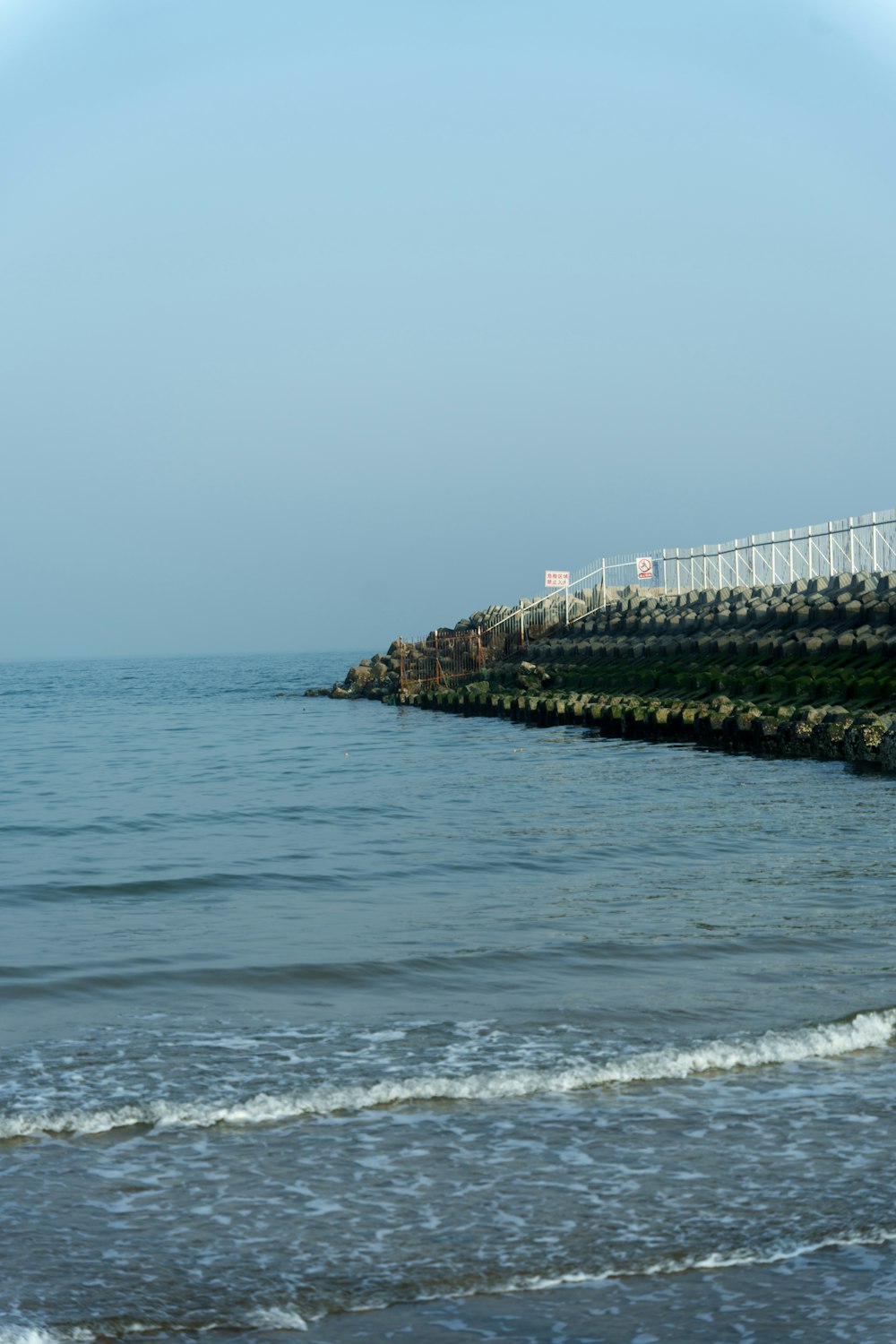 a view of the ocean from the shore of a beach