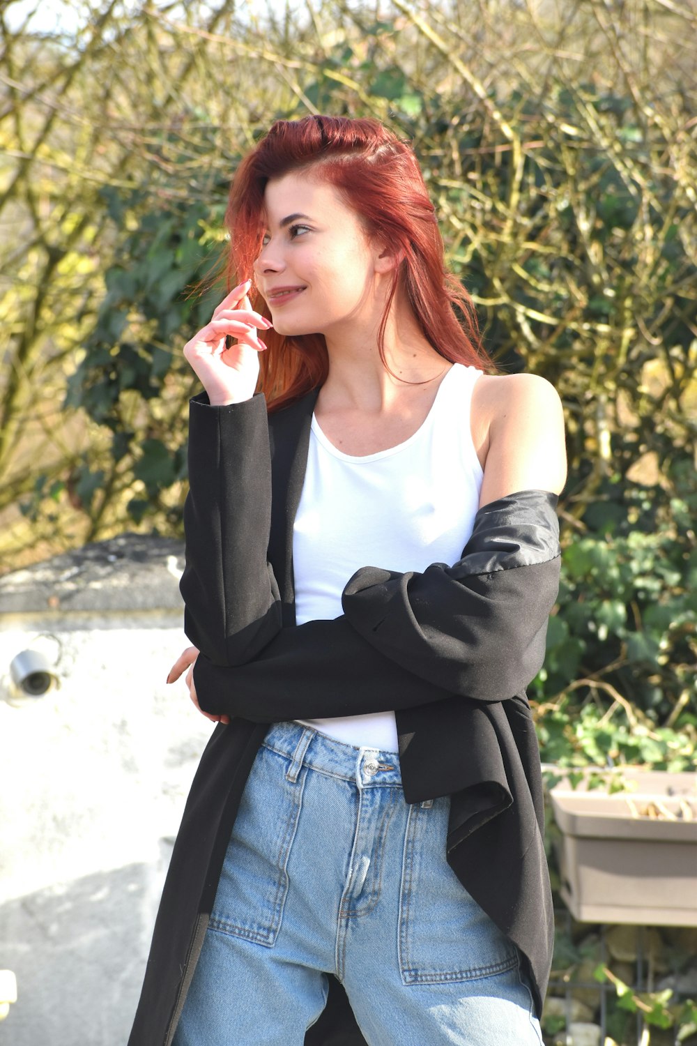 a woman with red hair is talking on a cell phone