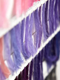 a close up of a row of different colored hair