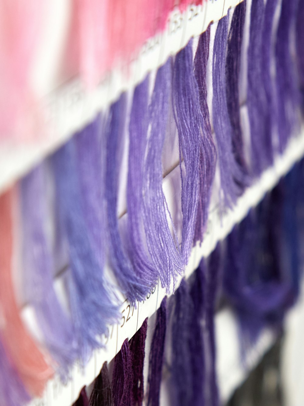 a close up of a row of different colored hair