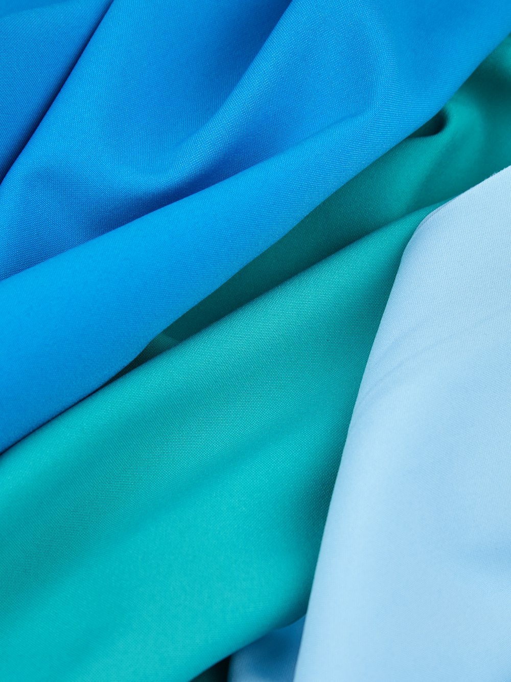 a close up of a blue and green fabric