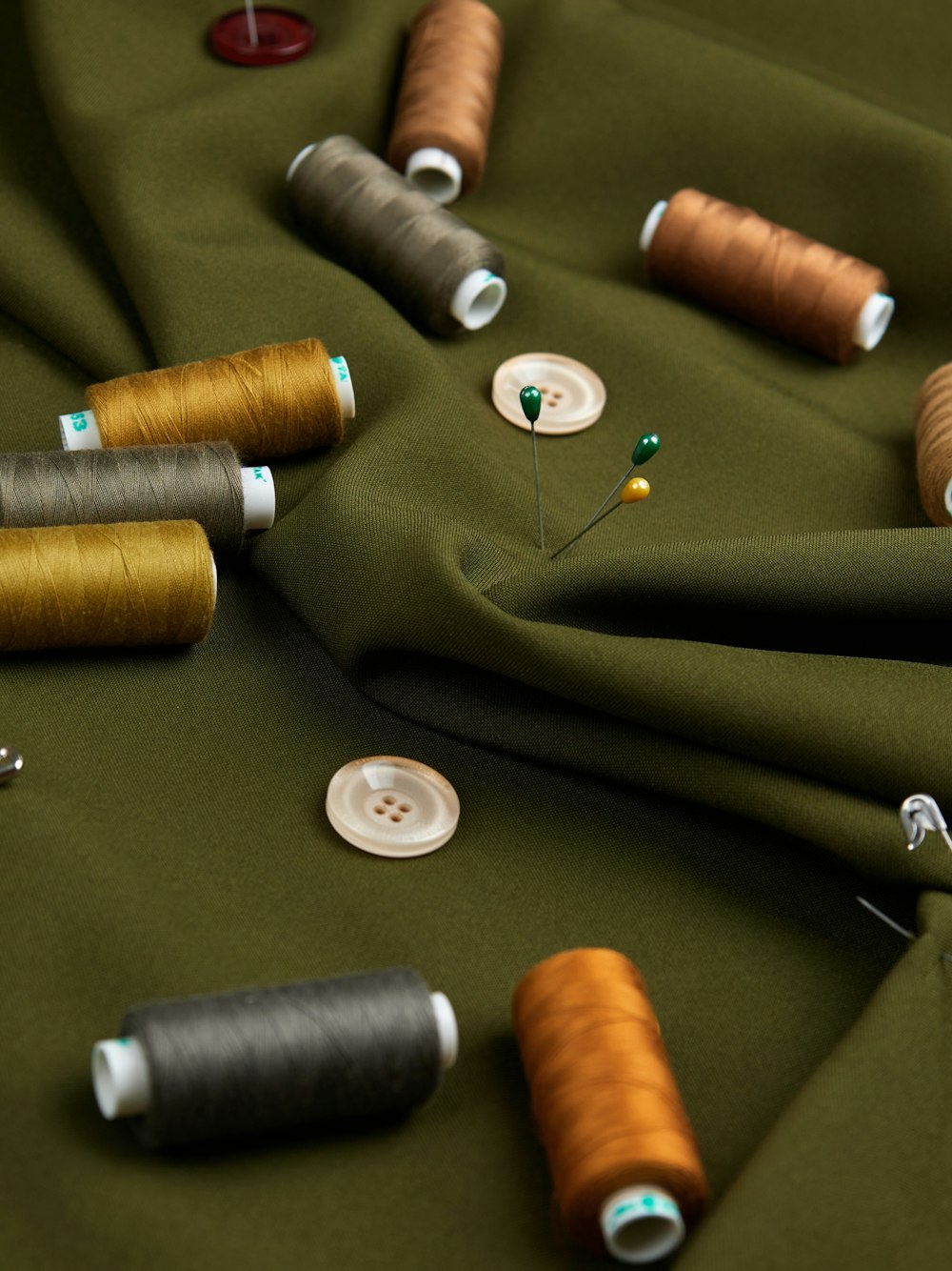 a table topped with lots of different colored spools of thread