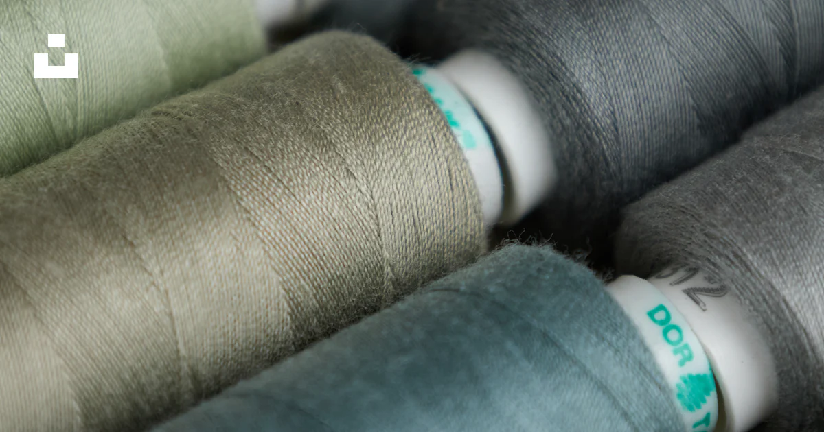 Thread Group Image A group of spools of thread sitting on top of each other photo – Free ...