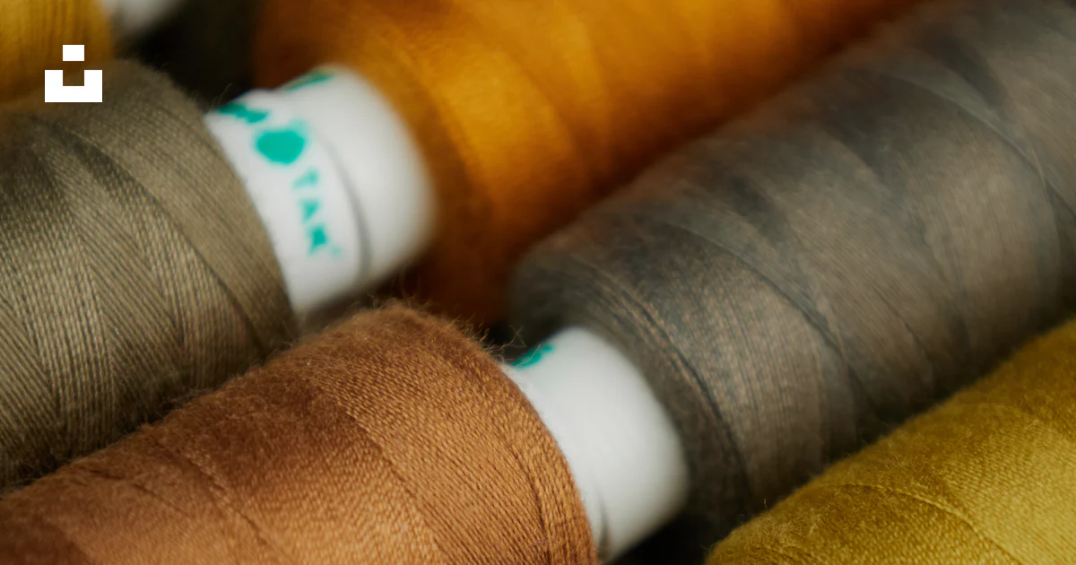 Thread Group Image A group of spools of thread sitting on top of each other photo – Free ...