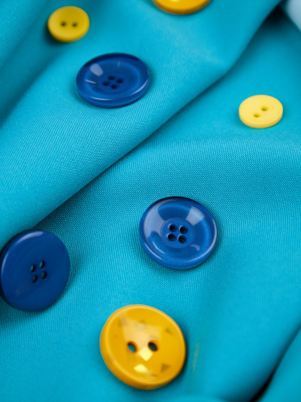 a close up of buttons on a blue cloth