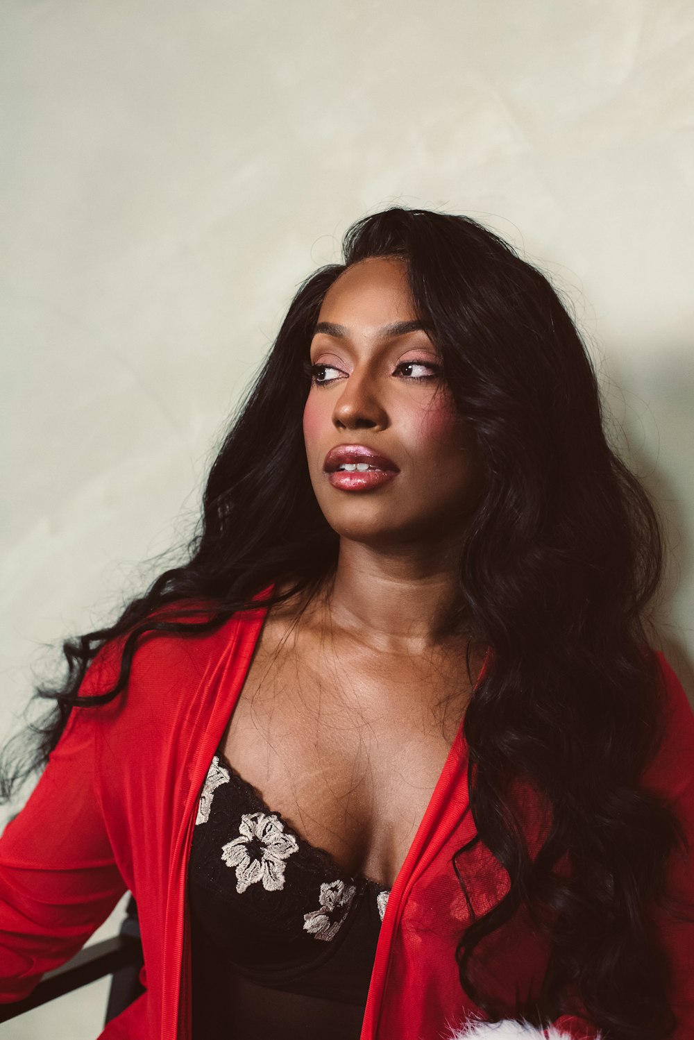 a woman in a red cardigan posing for a picture