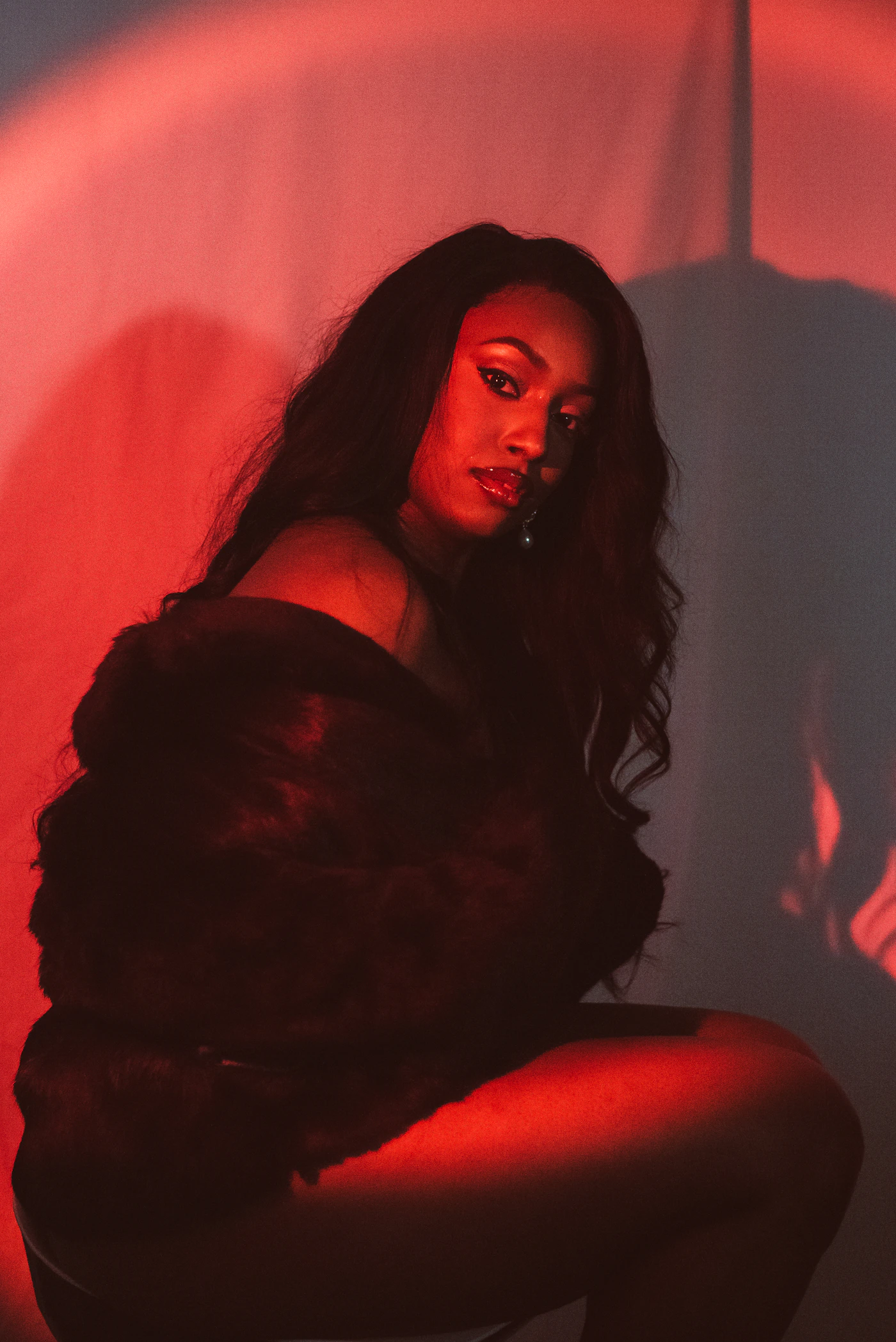 Creator posed in dramatic red editorial lighting
