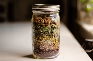 a glass jar filled with different types of food