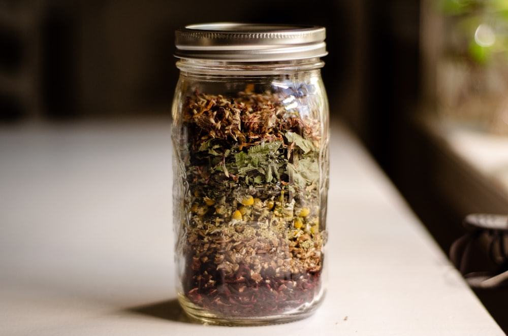 a glass jar filled with different types of food