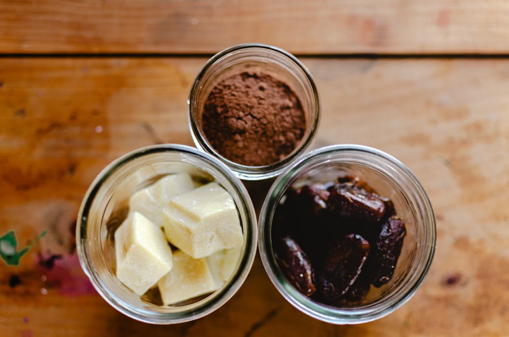 three jars filled with different types of food