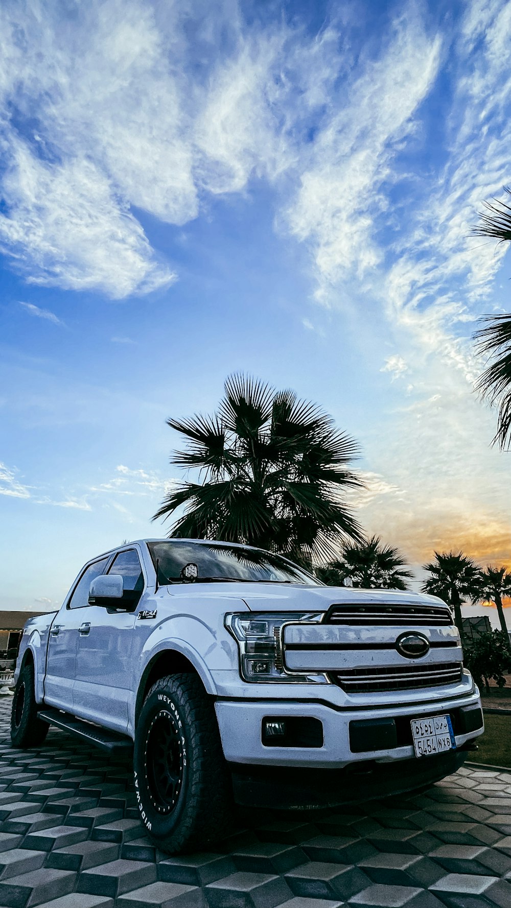 a white truck parked on top of a checkered floor