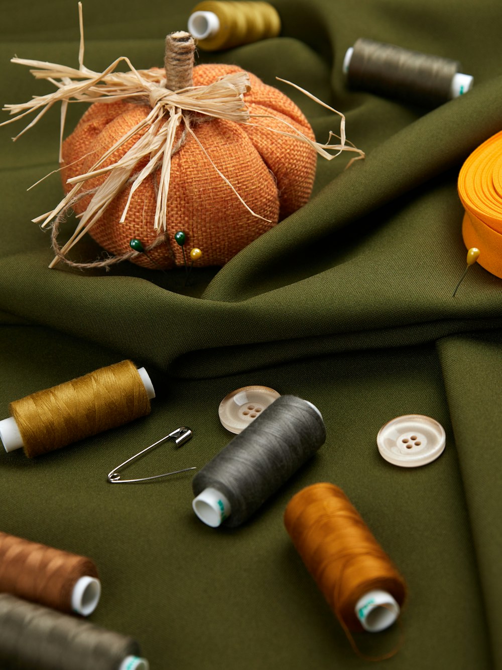a table topped with different types of thread and spools of thread