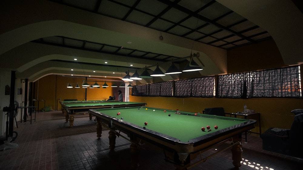 a pool table in a dimly lit room