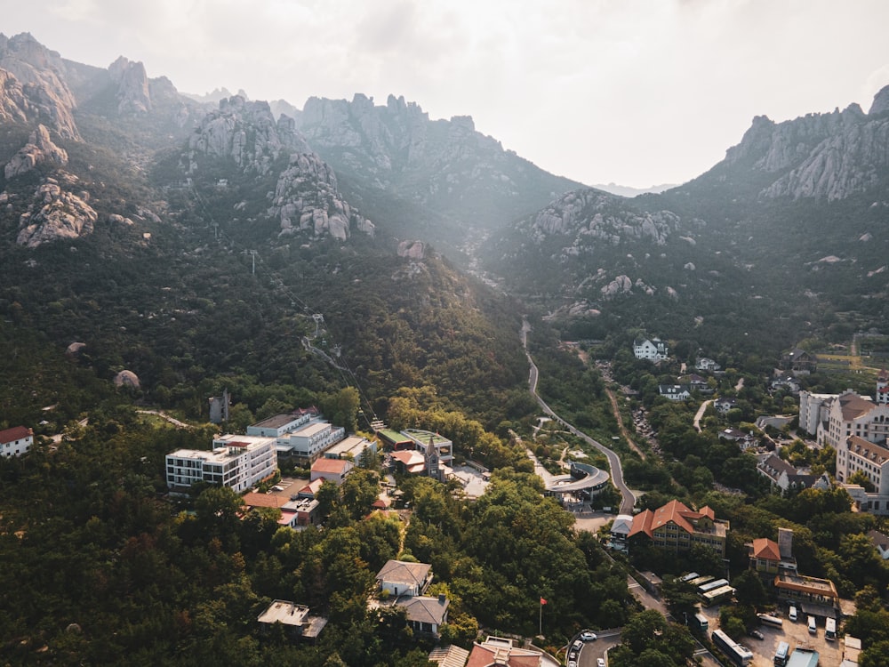 an aerial view of a city surrounded by mountains